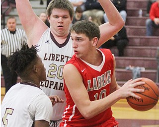 William D. Lewis The Vindicator  LaBrae's CLogan Kiser(10) keeps the ball from  Liberty'sMicahel rushton(5) and Derek Gilcher(20) during Jan 24, 2017 action at Liberty.