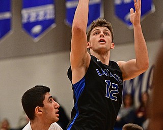 HUBBARD, OHIO - JANUARY 24, 2016: Chris Muir #12 of Lakeview puts up a shot over Bashar Rasoul #5 of Hubbard during the first half of their game Tuesday night at Hubbard High School. DAVID DERMER | THE VINDICATOR