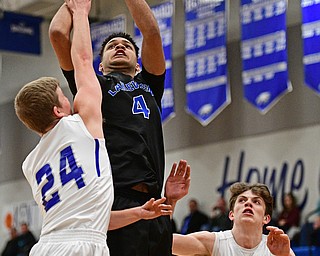 HUBBARD, OHIO - JANUARY 24, 2016: Jatise Garrison #4 of Lakeview puts up a shot over Travis Kopanic #24 of Hubbard while being pressured from behind by Jared Southern #30 during the first half of their game Tuesday night at Hubbard High School. DAVID DERMER | THE VINDICATOR