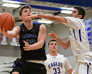HUBBARD, OHIO - JANUARY 24, 2016: Chris Muir #12 of Lakeview goes tot he basket while being pressured by Bashar Rasoul #5 of Hubbard during the first half of their game Tuesday night at Hubbard High School. DAVID DERMER | THE VINDICATOR