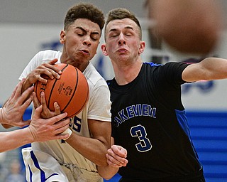 HUBBARD, OHIO - JANUARY 24, 2016: Davion Daniels #4 of Hubbard protects the ball while being pressured by Austin Shortreed #3 of Lakeview during the first half of their game Tuesday night at Hubbard High School. DAVID DERMER | THE VINDICATOR