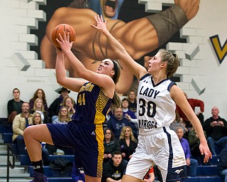 MICHAEL G TAYLOR | THE VINDICATOR- 01-25-17 - Basketball - 4th qtr., Champion's #44 Allison Smith drives to the hoop for the score against Brookfield's #30 Dana Sydlowski. Champion Lady Flashes vs Brookfield Lady Warriors at Brookfield High School in Brookfield, OH