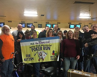 Neighbors | Submitted.The Mike Hull Memorial Family Mini Grant Committee presents its 2016 gifts to grant recipients during a pizza party at Strikers in Youngstown.  Committee members worked with the Autism Society to create the Family Mini Grant with proceeds from the Fourth Annual Mike Hull Memorial Poker Run for Autism last August.