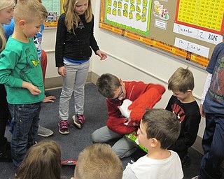 Neighbors | Alexis Bartolomucci.Students in Sue Flasco's class played a game where they had to unwrap a present using oven mitts during the last day of class before break at Union Elementary.