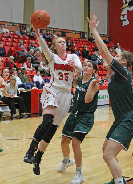 Youngstown State's Kelley Wright (35) goes up for a layup while being defended by Green Bay's Jen Wellnitz (1) and Lexi Weitzer (33)  during the first half of Thursday nights matchup at the Beeghly Center.   Dustin Livesay  |  The Vindicator  1/26/17  YSU