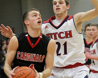 William D. Lewis The Vindicator Canfield's Brandon McFall(4) shoots past Fitch's Dylan Beany(21) during Jan 27, 2017 action at Fitch.