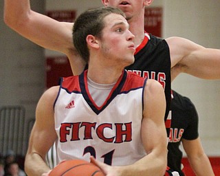 William D. Lewis The Vindicator Fitch's Dylan Beany(21) drives around Canfield's Jake Cummings(1) during Jan. 27, 2017 action at Fitch.