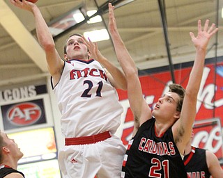 William D. Lewis The Vindicator  Fitch's Dylan Beany(21 shoots over Canfield's Zach Tinkey(21) during Jan. 27, 2017 action at Fitch.