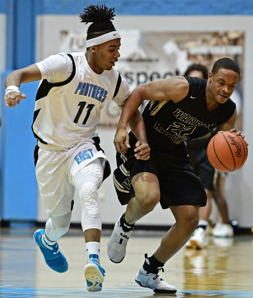 YOUNGSTOWN, OHIO - JANUARY 27, 2017: Lynn Williams #22 of Harding drives on Terrell Engles #11 of East during the first half of their game Friday night at East High School. DAVID DERMER | THE VINDICATOR