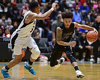 YOUNGSTOWN, OHIO - JANUARY 27, 2017: Chris Hughes #23 of Harding drives on Ce'andre Backus #5 of East during the first half of their game Friday night at East High School. DAVID DERMER | THE VINDICATOR