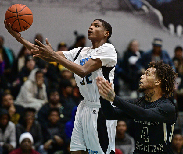 YOUNGSTOWN, OHIO - JANUARY 27, 2017: Shannon Dubose #32 of East goes to the basket while being pressured by Lynn Bowden #4 of Harding during the first half of their game Friday night at East High School. DAVID DERMER | THE VINDICATOR