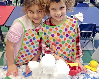 SPECIAL TO THE VINDICATOR
Students in Barbara Conti’s preschool enrichment class at Ursuline Preschool and Kindergarten brought snow into the classroom to play with since it was too cold to play outside. Ray Thomas, left, and Lucia White learned how to measure the depth of a pile of snow with rulers.