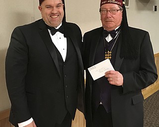 SPECIAL TO THE VINDICATOR: 
Shrine Club donates $15K to
Shriners Hospitals for Children
Lou Garland, left, president of Youngstown Shrine Club, recently presented donations totaling $15,000 to Al York, member of Cincinnati Board of Governors, who accepted the donation on behalf of Shriners Hospitals for Children-Cincinnati. The club has designated $5,000 for a summer camp for burn patients and $10,000 for its rehabilitation unit. Shriners Hospital for Children-Cincinnati is one of 22 Shriner Hospitals in North America. It specializes in burn care, plastic surgery, reconstruction surgeries and complex wound and skin conditions. The hospital accepts and treats patients regardless of their ability to pay. Youngstown Shrine Club raises money through donations and public events to support the hospitals. The next event is its annual beer taste Feb. 4. Tickets can be purchased by calling 330-259-1216 or 330-792-8892.