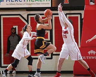 Milwaukee junior guard Bailey Farley(4) goes up for the layup against Youngstown State junior forward Morgan Olson(25) and Youngstown State sophomore guard Alison Smolinski(2) during the third quarter as the Youngstown State Penguins take on the University of Wisconsin Milwaukee Panthers at the Beeghly Center in Youngstown on Saturday, Jan. 28, 2017. The Panthers won, 78-74...(Nikos Frazier | The Vindicator)..