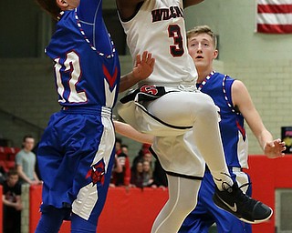 MICHAEL G TAYLOR | THE VINDICATOR- 01-28-17 -Basketball-  1st qtr., Struther's #3 Kevin Traylordrives against Reserve's #12  Rilet Millerfor the score.  Western Reserve Blue Devils  vs Struthers Wildcats at Struthers High School in Struthers Fieldhouse, Struthers,, OH..