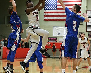 MICHAEL G TAYLOR | THE VINDICATOR- 01-28-17 -Basketball-  1st qtr., Struther's #3 Kevin Traylor splits Reserve's #2 Dom Velasquez and #12 (left) Rilet Millerfor the score.  Western Reserve Blue Devils  vs Struthers Wildcats at Struthers High School in Struthers Fieldhouse, Struthers,, OH..