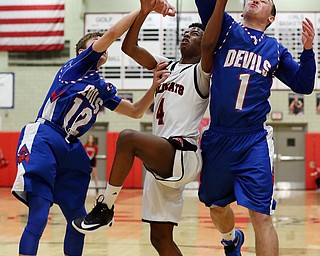 MICHAEL G TAYLOR | THE VINDICATOR- 01-28-17 -Basketball-  1st qtr., Struther's #4 Ja'Juan Douglas (middle), Reserve's #12  Riley Miller and #1 Wyatt Larimer battle for the rebound.  Western Reserve Blue Devils vs Struthers Wildcats at Struthers High School in Struthers Fieldhouse, Struthers, OH.