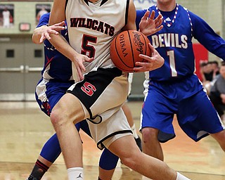 MICHAEL G TAYLOR | THE VINDICATOR- 01-28-17 -Basketball-  1st qtr., Struther's #5 Andrew Carbon is grabed by Reserve's #12 Riley Miller as he drives ot the hoop.  Western Reserve Blue Devils vs Struthers Wildcats at Struthers High School in Struthers Fieldhouse, Struthers, OH.