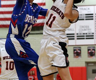MICHAEL G TAYLOR | THE VINDICATOR- 01-28-17 -Basketball-  1st qtr., Struther's #11 Ethan Vo is fouled by Reserve's #12 Riley Miller as he drives ot the hoop.  Western Reserve Blue Devils vs Struthers Wildcats at Struthers High School in Struthers Fieldhouse, Struthers, OH.