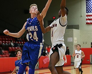 MICHAEL G TAYLOR | THE VINDICATOR- 01-28-17 -Basketball-  1st qtr., Struther's #5 Ja'Juan Douglas scores against Reserve's #24 (left) Kade Hilles for the score.  Western Reserve Blue Devils  vs Struthers Wildcats at Struthers High School in Struthers Fieldhouse, Struthers, OH.