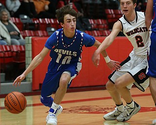 MICHAEL G TAYLOR | THE VINDICATOR- 01-28-17 -Basketball-  3rd qtr., Reserve's #10 Ryan Demsky blows by Struther's #2 Carson Ryan.  Western Reserve Blue Devils vs Struthers Wildcats at Struthers High School in Struthers Fieldhouse, Struthers, OH..