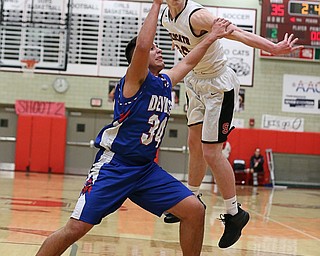 MICHAEL G TAYLOR | THE VINDICATOR- 01-28-17 -Basketball-  3rd qtr., Struther's #20 Ryan Leonard slaps  the ball out of the hands of Reserve's #34 Jack Cappabianca.  Western Reserve Blue Devils vs Struthers Wildcats at Struthers High School in Struthers Fieldhouse, Struthers, OH..