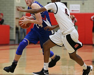 MICHAEL G TAYLOR | THE VINDICATOR- 01-28-17 -Basketball-  3rd qtr., Reserve's #24  Kade Hilles drives against Struther's #4 Ja'Juan Douglas.  Western Reserve Blue Devils  vs Struthers Wildcats at Struthers High School in Struthers Fieldhouse, Struthers, OH.