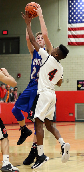 MICHAEL G TAYLOR | THE VINDICATOR- 01-28-17 -Basketball-  3rd qtr., Reserve's #24  Kade Hilles shoots over Struther's #4 Ja'Juan Douglas.  Western Reserve Blue Devils  vs Struthers Wildcats at Struthers High School in Struthers Fieldhouse, Struthers, OH.