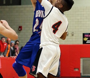 MICHAEL G TAYLOR | THE VINDICATOR- 01-28-17 -Basketball-  3rd qtr., Reserve's #24  Kade Hilles shoots over Struther's #4 Ja'Juan Douglas.  Western Reserve Blue Devils  vs Struthers Wildcats at Struthers High School in Struthers Fieldhouse, Struthers, OH.