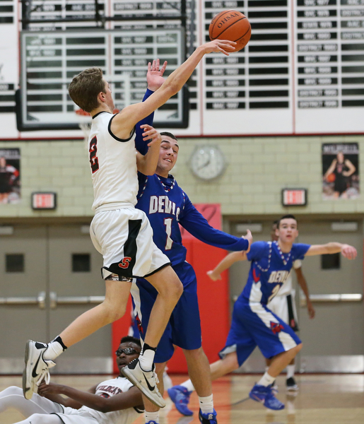  MICHAEL G TAYLOR | THE VINDICATOR- 01-28-17 -Basketball-  3rd qtr., Struther's #2 Carson Ryan pass against the defense of Reserve's #1 Wyatt Larimer.  Western Reserve Blue Devils  vs Struthers Wildcats at Struthers High School in Struthers Fieldhouse, Struthers,, OH..