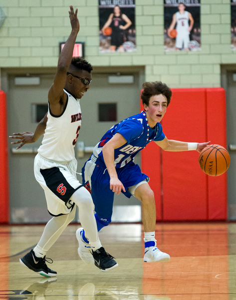 MICHAEL G TAYLOR | THE VINDICATOR- 01-28-17 -Basketball-  4th qtr., Reserve's #10 Ryan Demsky dribbles up court againsts Struther's #3 Kevin Traylor.  Western Reserve Blue Devils vs Struthers Wildcats at Struthers High School in Struthers Fieldhouse, Struthers, OH..