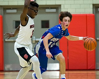 MICHAEL G TAYLOR | THE VINDICATOR- 01-28-17 -Basketball-  4th qtr., Reserve's #10 Ryan Demsky dribbles up court againsts Struther's #3 Kevin Traylor.  Western Reserve Blue Devils vs Struthers Wildcats at Struthers High School in Struthers Fieldhouse, Struthers, OH..