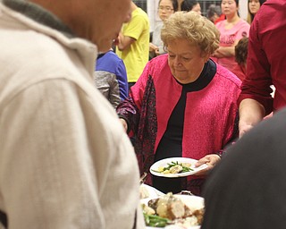 Lynn Pebworth of Canfield plates some Chinese food during the Chinese New Year Celebration at Poland United Methodist Church in Poland on Sunday, Jan. 29, 2017. ..(Nikos Frazier | The Vindicator)..