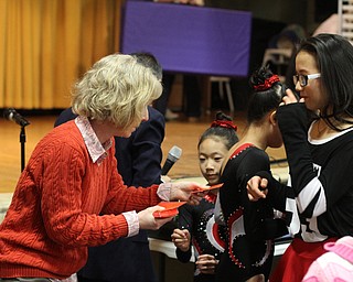 Holly Grant, Pastor Michael Grant's wife, passes out a red envelope to Anna Zheng(13) during the Chinese New Year Celebration at Poland United Methodist Church in Poland on Sunday, Jan. 29, 2017. ..(Nikos Frazier | The Vindicator)..