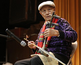 Xu Shougjiang, 81, of Xinjiang, China performs during the Chinese New Year Celebration at Poland United Methodist Church in Poland on Sunday, Jan. 29, 2017. Shougjiang taught himself how to play the two string Chinese fiddle, the Jinghu, by listening to music on the radio. ..(Nikos Frazier | The Vindicator)..