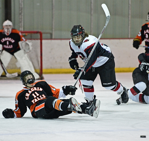 BOARDMAN, OHIO - JANUARY 29, 2017: Tony Cole #88 of Canfield follows through with his check as Matt McCluskey #11 of Chagrin Falls slides on the ice during the first period of their game Sunday afternoon at the Ice Zone. DAVID DERMER | THE VINDICATOR