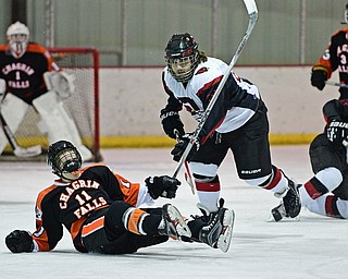 BOARDMAN, OHIO - JANUARY 29, 2017: Tony Cole #88 of Canfield follows through with his check as Matt McCluskey #11 of Chagrin Falls slides on the ice during the first period of their game Sunday afternoon at the Ice Zone. DAVID DERMER | THE VINDICATOR