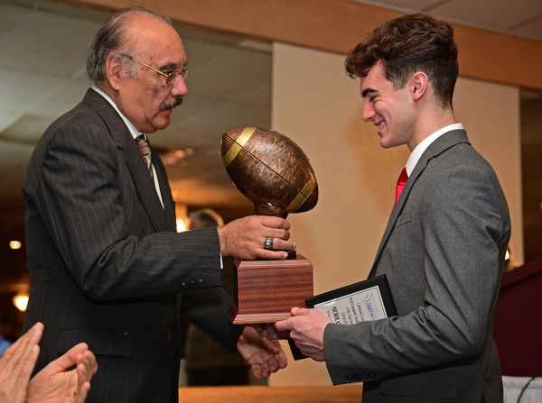 BOARDMAN, OHIO - JANUARY 29, 2017: Nick Hall of Girard is presented the Byrd Giampetro Trophy by Curbstone Coaches chair member Frank Nolasco after winning the Student Athlete of the Year Scholarship, Sunday evening at the Georgetown. DAVID DERMER | THE VINDICATOR
