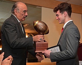 BOARDMAN, OHIO - JANUARY 29, 2017: Nick Hall of Girard is presented the Byrd Giampetro Trophy by Curbstone Coaches chair member Frank Nolasco after winning the Student Athlete of the Year Scholarship, Sunday evening at the Georgetown. DAVID DERMER | THE VINDICATOR