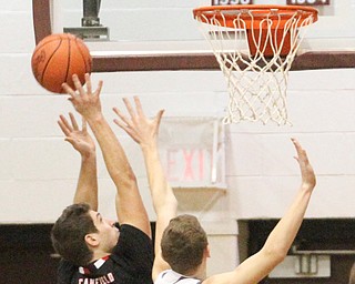 Canfield senior forward Jared Clark(13)(left) jumps up as Boardman junior guard Holden Lipke(3)(right) during the first quarter as Canfield High School takes on Boardman High School at Boardman High School  in Boardman on Tuesday, Jan. 31, 2017. Boardman won 51-44...(Nikos Frazier | The Vindicator)..