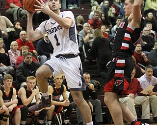 Boardman senior guard John Ryan(1) goes for the layup during the first quarter as Canfield High School takes on Boardman High School at Boardman High School  in Boardman on Tuesday, Jan. 31, 2017. Boardman won 51-44. Also pictured Canfield junior guard Ethan Kalina(12)...(Nikos Frazier | The Vindicator)..