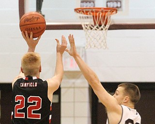 Canfield junior guard Ian McGraw(22) goes up for three as Boardman senior forward Coleman Stauffer(20) tries to block the shot during the first quarter as Canfield High School takes on Boardman High School at Boardman High School  in Boardman on Tuesday, Jan. 31, 2017. Boardman won 51-44...(Nikos Frazier | The Vindicator)..