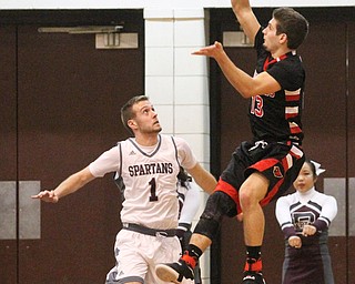 Canfield senior forward Jared Clark(13) attempts to shoot the ball before falling out of bounds during the second quarter as Canfield High School takes on Boardman High School at Boardman High School  in Boardman on Tuesday, Jan. 31, 2017. Boardman won 51-44. Also pictured, Boardman senior guard John Ryan(1)...(Nikos Frazier | The Vindicator)..