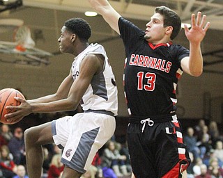 Boardman sophomore guard Che Trevena(32) goes up for the layup as Canfield senior forward Jared Clark(13) tries to block the shot during the second quarter as Canfield High School takes on Boardman High School at Boardman High School  in Boardman on Tuesday, Jan. 31, 2017. Boardman won 51-44...(Nikos Frazier | The Vindicator)..