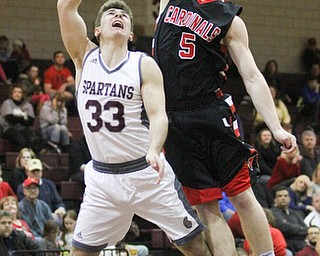 Canfield junior guard Tyler Dobrindt(5) goes up to block Boardman junior guard Dom Stilliana(33)'s shot during the second quarter as Canfield High School takes on Boardman High School at Boardman High School  in Boardman on Tuesday, Jan. 31, 2017. Boardman won 51-44...(Nikos Frazier | The Vindicator)..