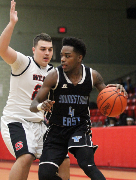 William D. Lewis The Vindicator East's Calvaughn Bryant(4) drives around Struthers' Tyrese Hawkins(24) during Jan 31, 2017 action at Struthers