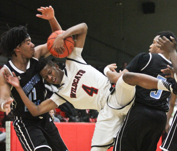 William D Lewis The Vindicator Struther's Jajuan Douglas(4) collides with East's Terrell Engles(11) and Vonzell Matlock(3) while bringing down a rebound during Jan. 31, 2017 action at Struthers.