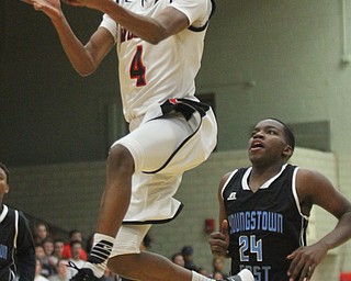 William D Lewis The Vindicator Struther's Jujuan Douglas(4) goes to the hoop past East's Larry Ransom(24) during Jan. 31, 2017 action at Struthers.