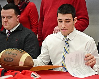 STRUTHERS, OHIO - FEBRUARY 1, 2017: A.J. Musolino, right, of Struthers signs his national letter of intent to play football at Kent State University, Wednesday afternoon at Struthers High School. DAVID DERMER | THE VINDICATOR