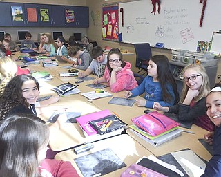 SPECIAL TO THE VINDICATOR
Members of the Mahoning Valley Historical Society recently visited fifth grade students at Brookfield Middle School. Members arranged the classroom with the desks together, like an old-fashioned school, and taught the students games that were 600 to 1,000 years old. Students tried on period clothing and learned to write with a quill pen.